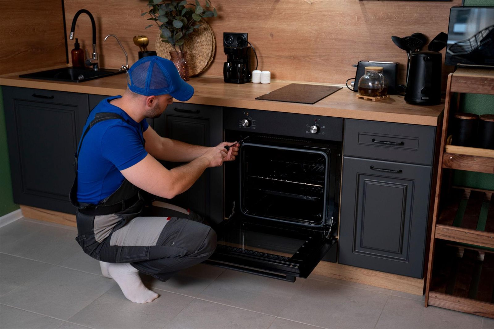 Technician repairing a gas oven in a Naperville, IL kitchen