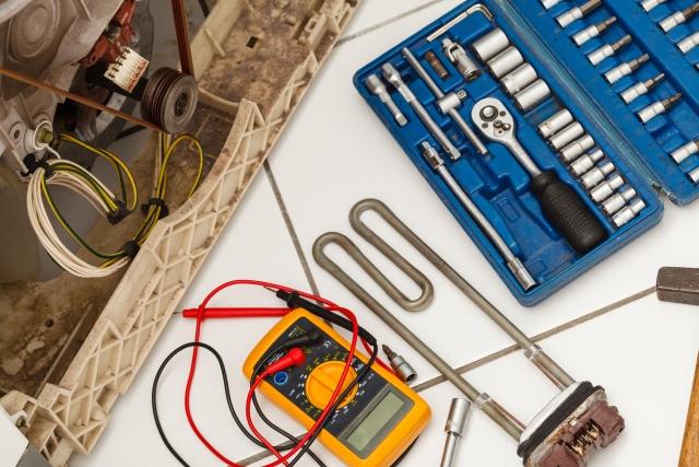 Technician repairing an appliance in a Naperville, IL kitchen